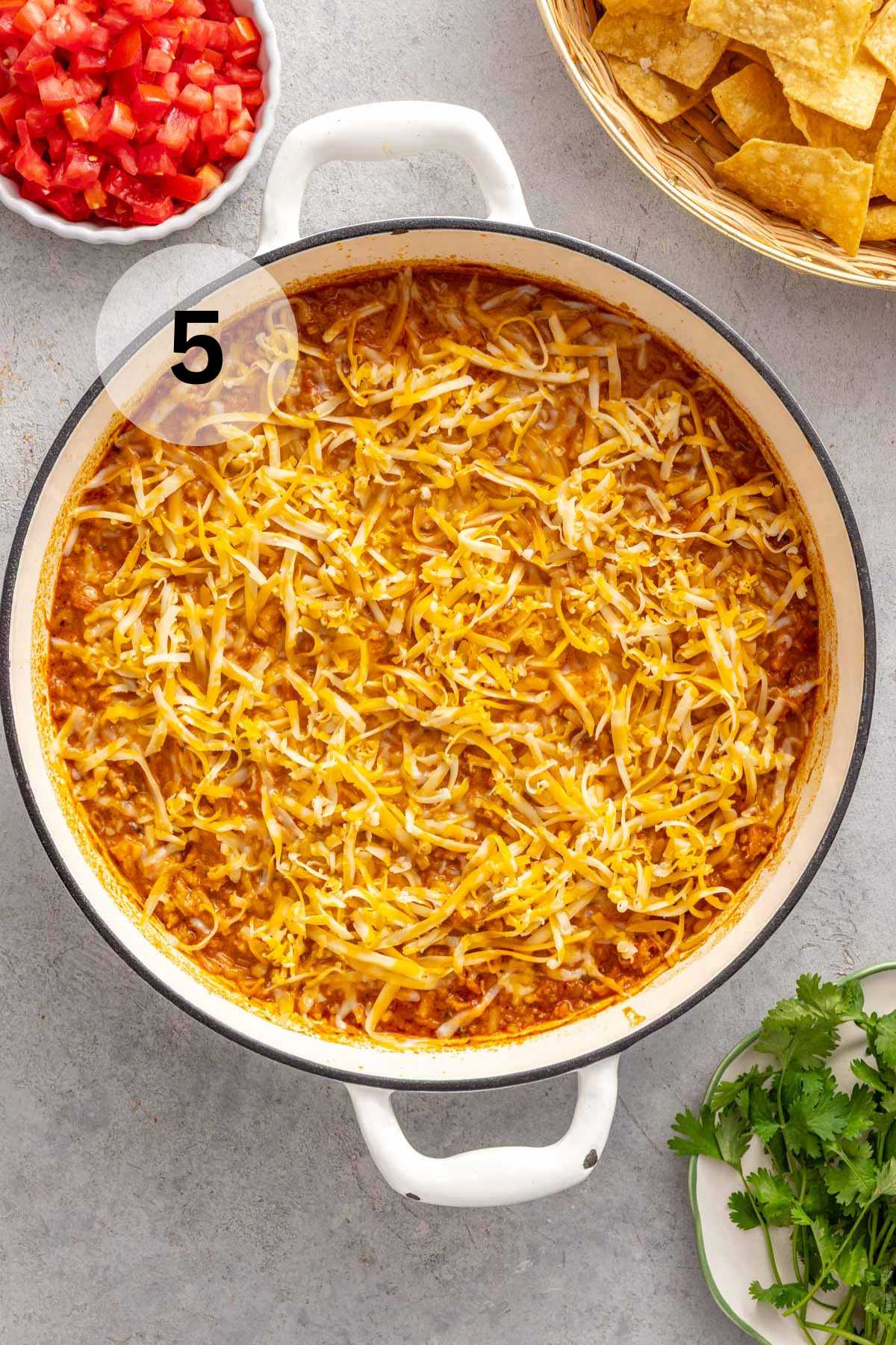 Shredded cheese sprinkled over Mexican chicken and rice.