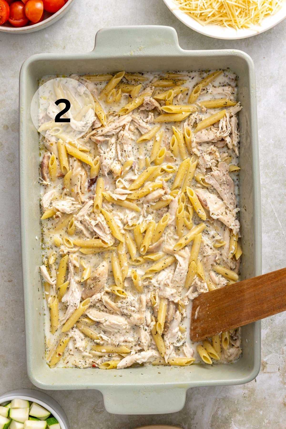 Stirring milk, broth, and dressing with chicken and pasta.