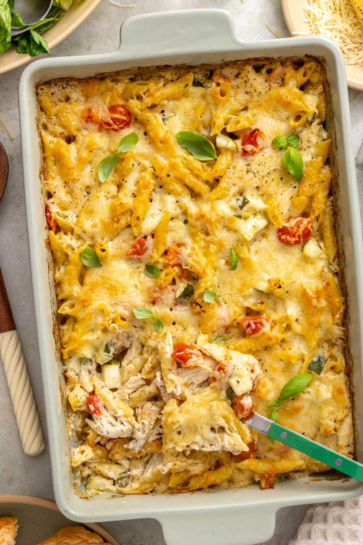 Scooping out a serving of chicken pasta bake.