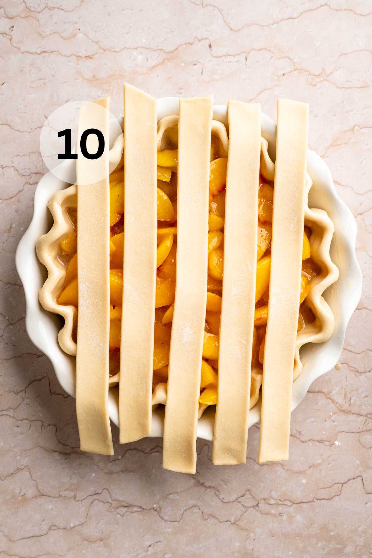 Adding strips of crust over the top of a peach pie.