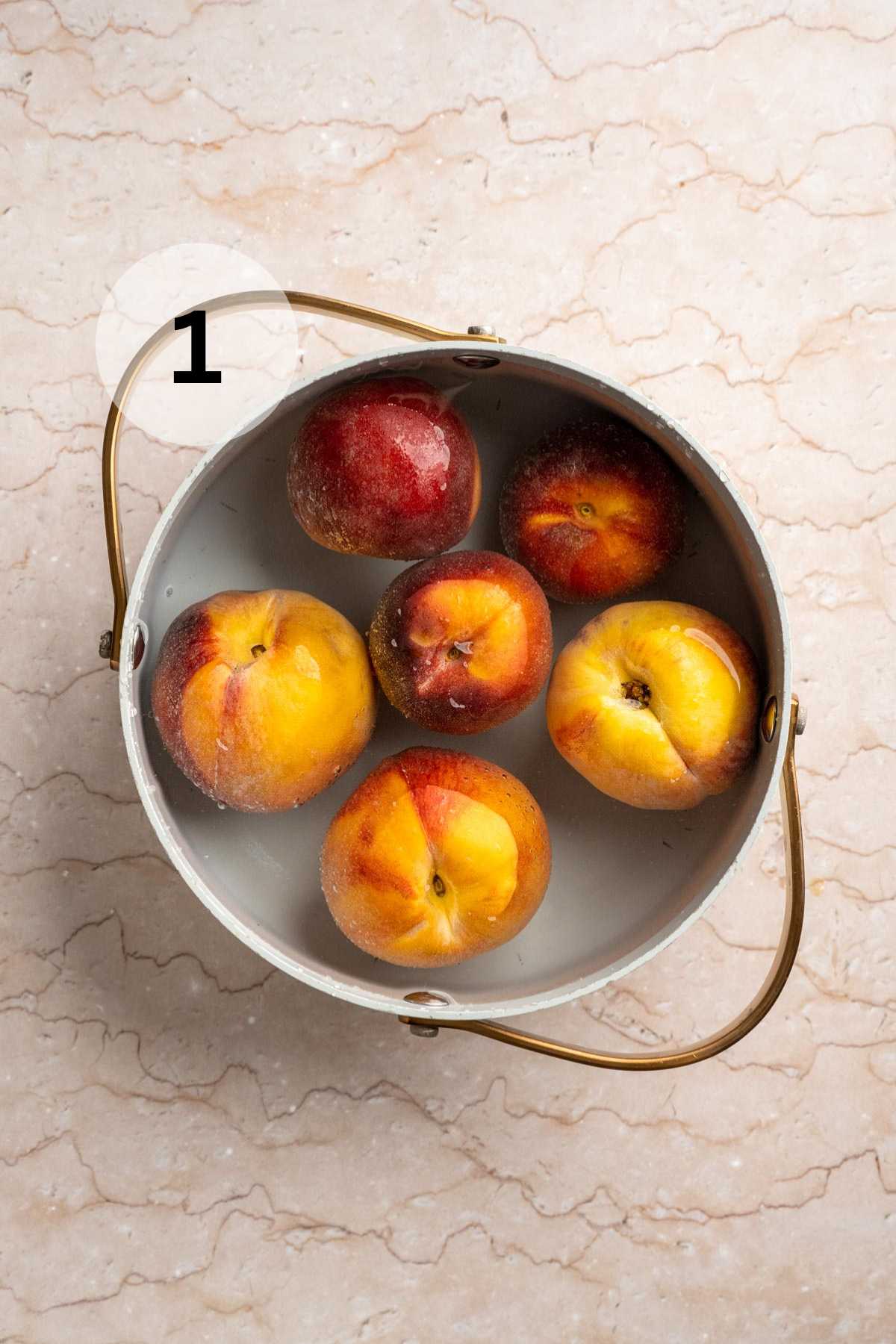 Peaches in a pot of water.