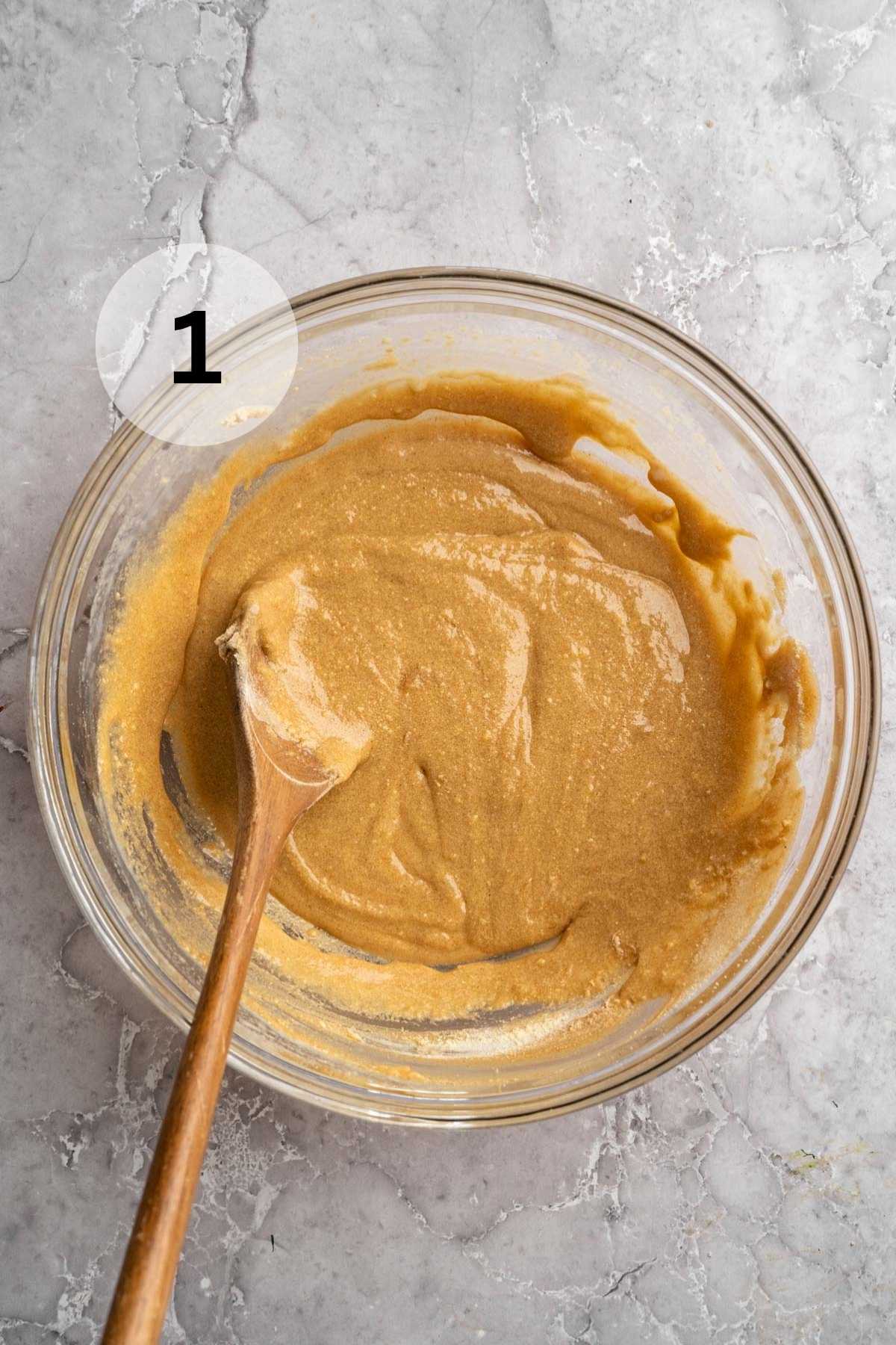 Stirring peanut butter with honey in a large bowl.