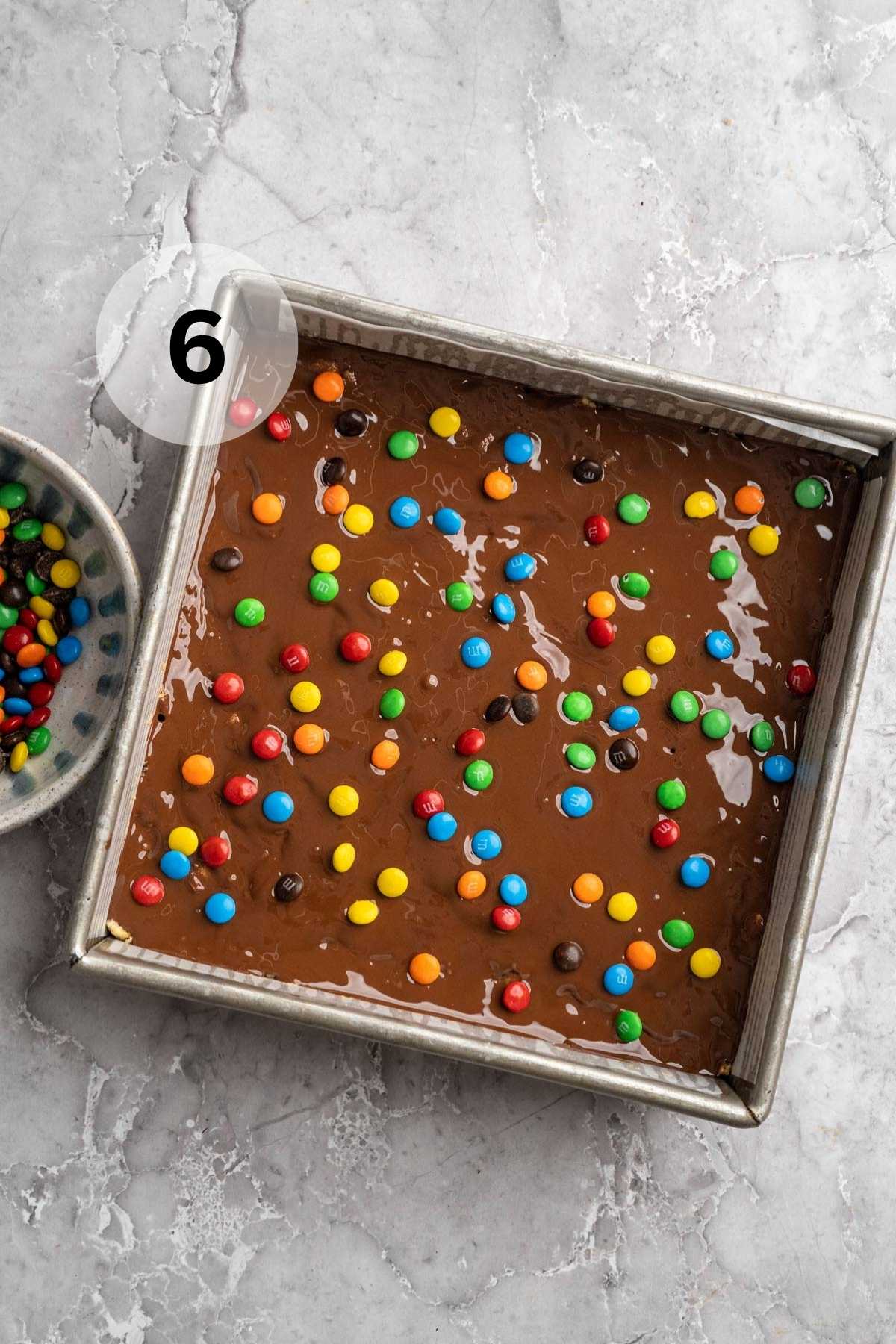 M&M's sprinkled over chocolate and peanut butter protein bars.