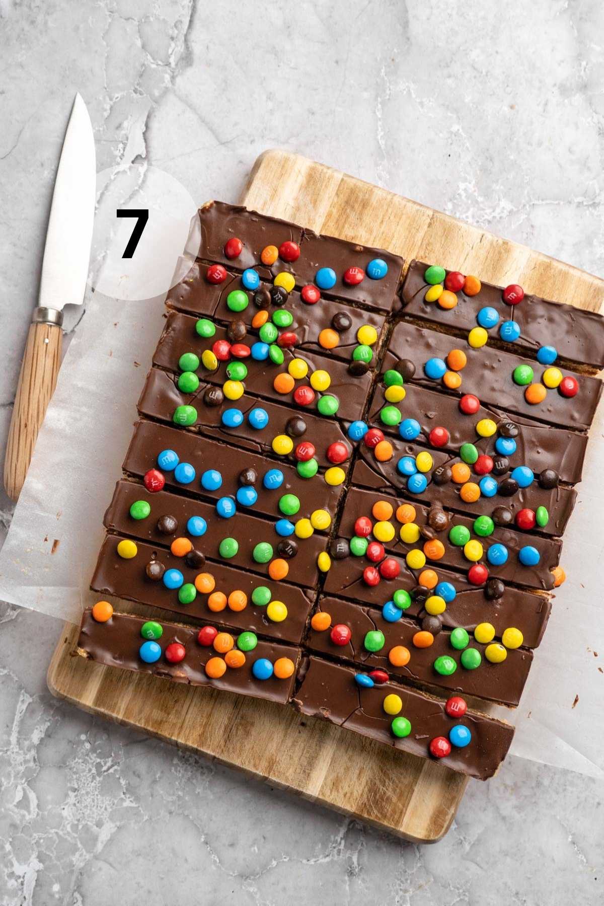 Homemade protein bars cut into rectangles on a cutting board.