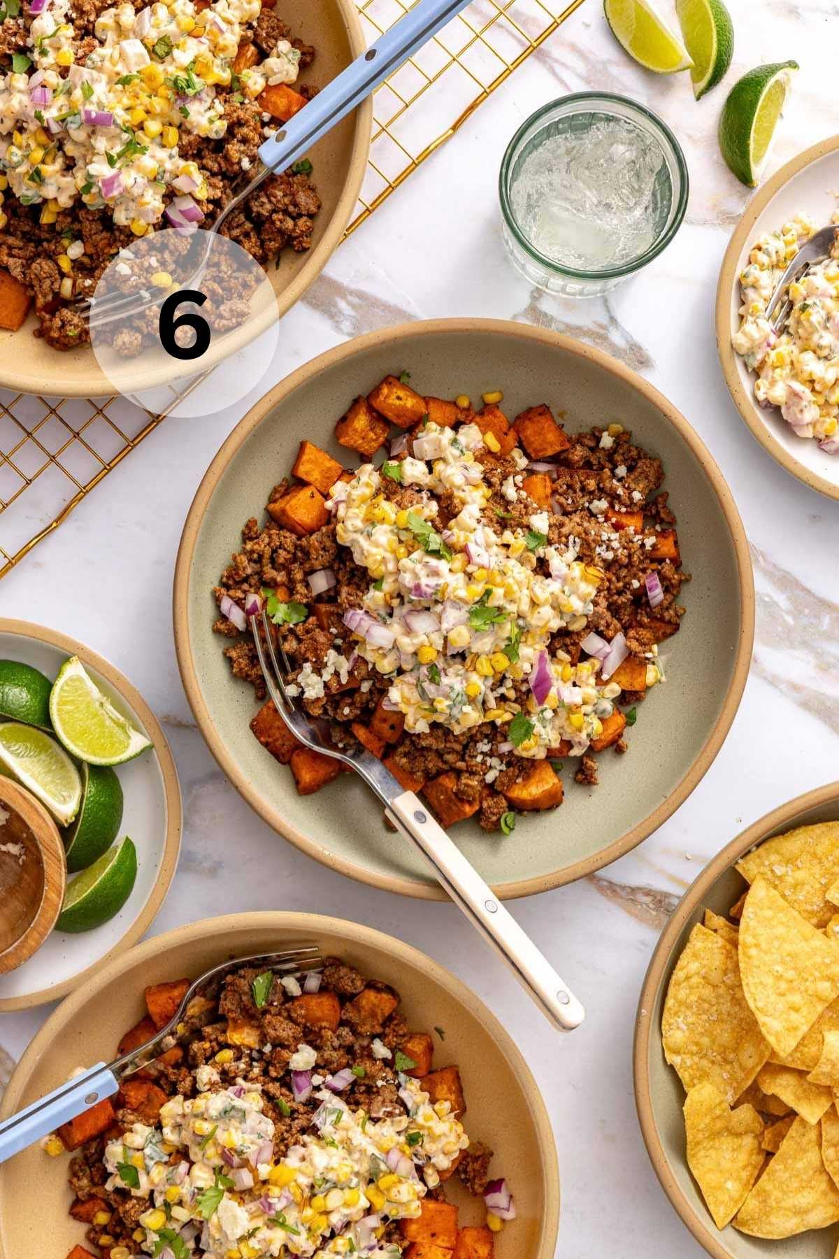 Sweet potato bowls served with tortilla chips and lime wedges.
