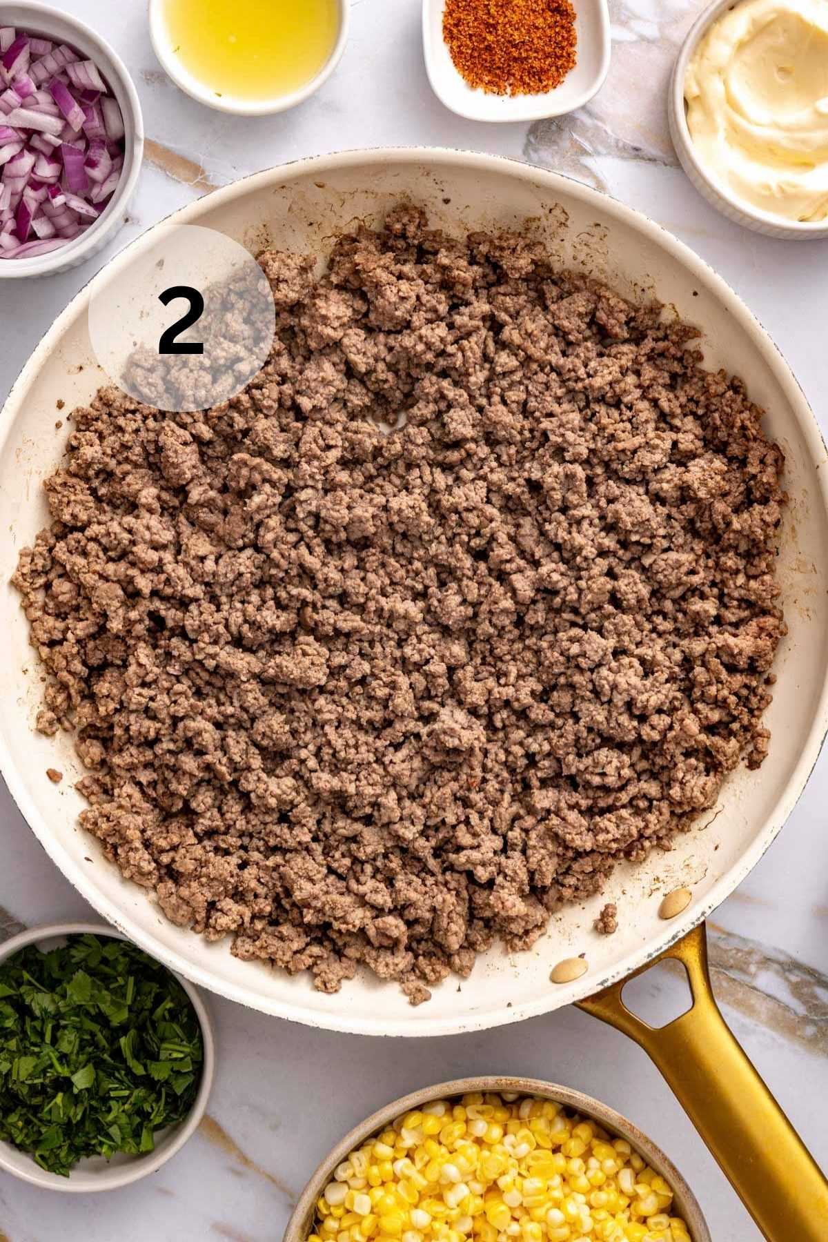 Cooked ground beef in a skillet.