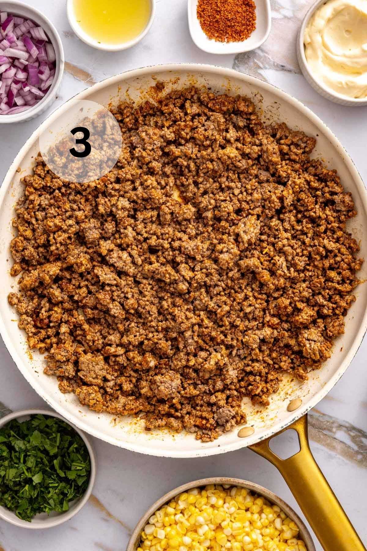 Seasoned ground beef in a skillet.