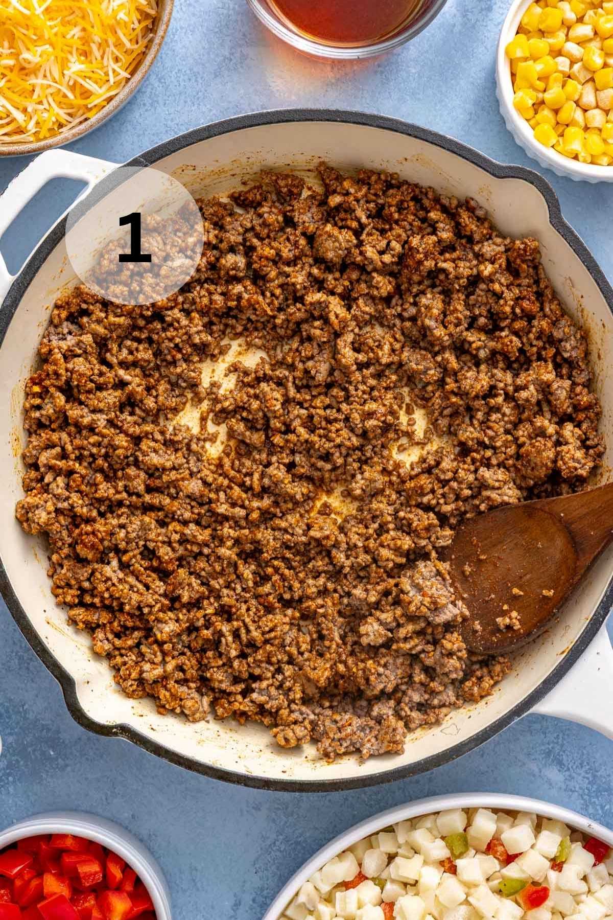 Stirring seasoned ground beef in a skillet.