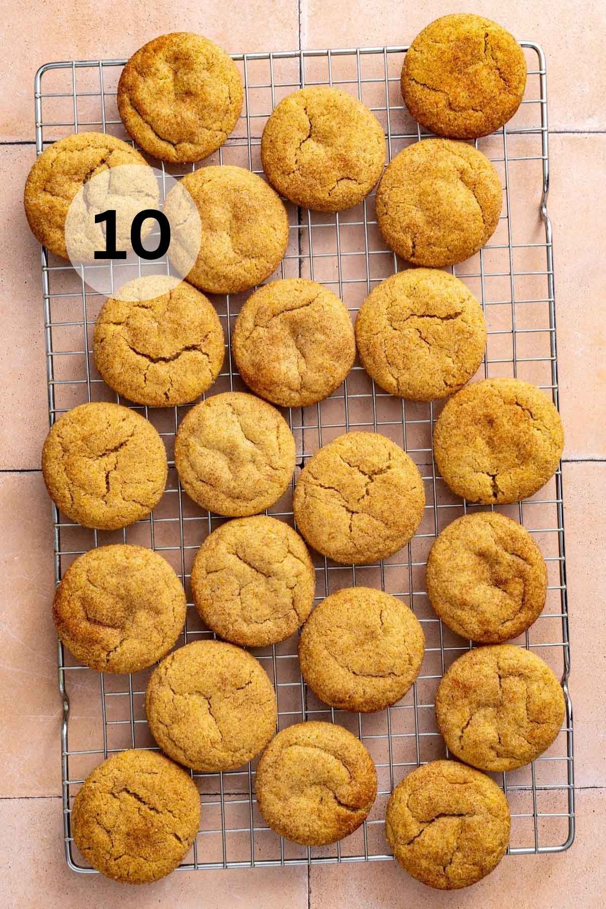 Baked snickerdoodles on a wire cooling rack.